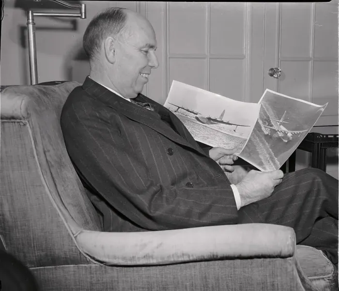 Framed Print : Owen Brewster Looking at Photos of Howard Hughes Plane Framed Print : Owen Brewster Looking at Photos of Howard Hughes Plane