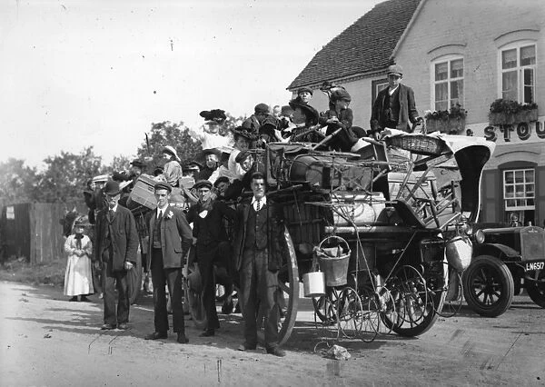 Packed Up. 7th September 1907: A family of hop pickers stand beside their