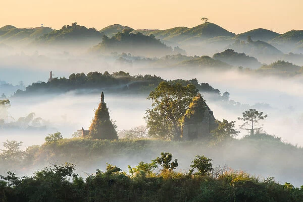 Pagodas and temples in the mist in Mrauk U, Myanmar. In the Morning time