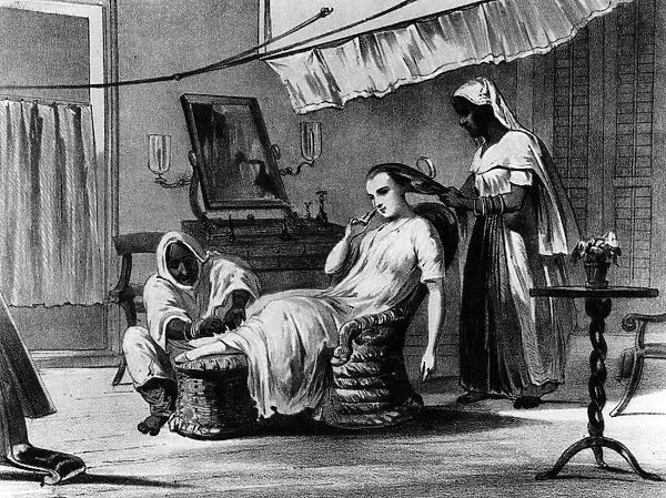 Pampering. circa 1860: A magistrates wife being groomed by her servants, in India