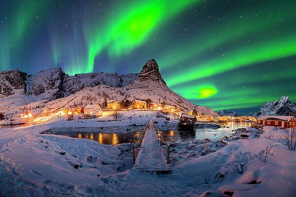 Panorama of Reine's wooden bridge with Aurora and Reine mountian in the background -stock photo