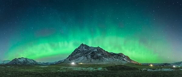 Panorama view of an aurora arch in south Iceland