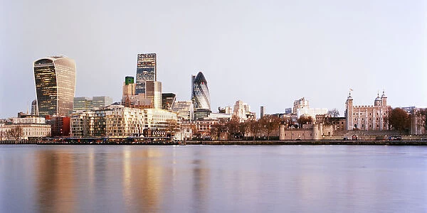 Panoramic view of city skyline across River Thames at sunrise