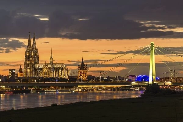 Panoramic view of the Rhine with Cologne Cathedral, Severinsbrucke Bridge, the Musical Dome and Great St. Martin Church, at dusk, Cologne, North Rhine-Westphalia, Germany