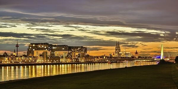 Panoramic view of the Rhine with Cologne Cathedral, Severinsbrucke Bridge, the Crane Houses, Great St. Martin Church and Colonius telecommunications tower, at dusk, Cologne, North Rhine-Westphalia, Germany