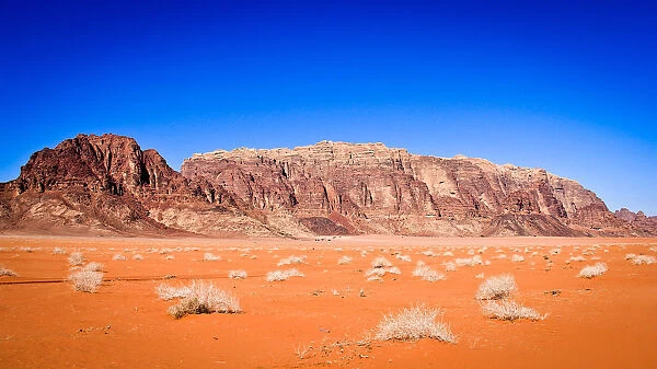 Panoramic view of Wadi Rum from a hilltop with clear blue sky background