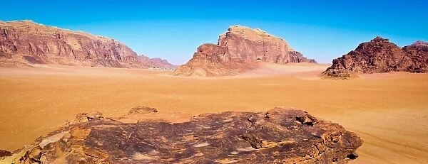 Panoramic view of Wadi Rum from a hilltop with clear blue sky background