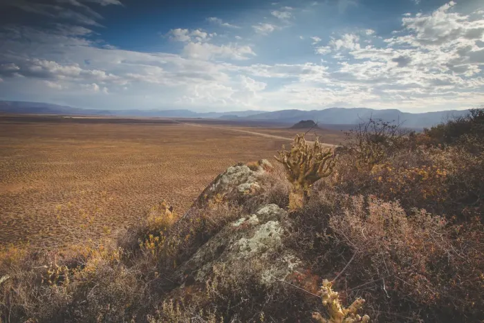 Framed Print : Panoramic views over the Tankwa Karoo Desert with dramatic thunderclouds in the sky