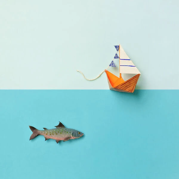 Paper boat and toy fish