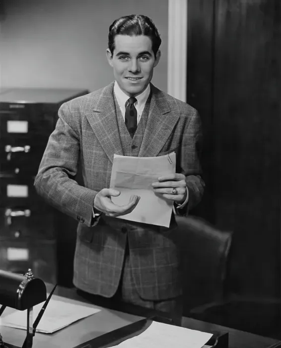 Framed Print : Paperwork. A young office worker with a document, circa 1955