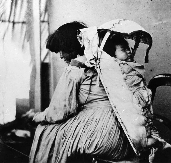 Papoose. A Native American of the Shoshone tribe with her child carried in a papoose