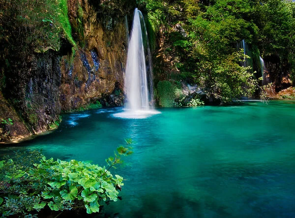 Paradise. A waterfall drops into a tranquil, turquoise pool at Plitvice