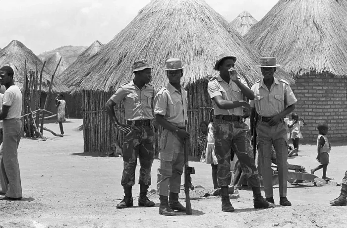Framed Print : Paramilitary Patrol Beside Huts Framed Print : Paramilitary Patrol Beside Huts