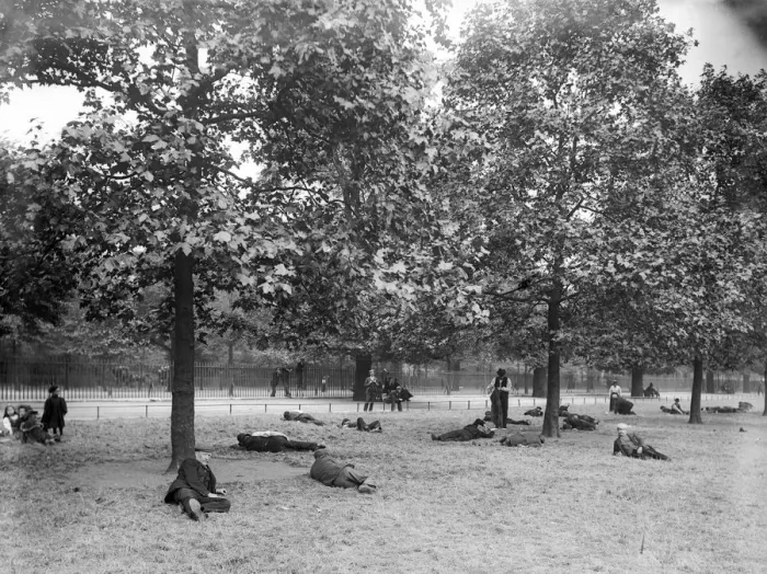 Framed Print : Park Rest. Unemployed men relax under the trees at St James Park in London Framed Print : Park Rest. Unemployed men relax under the trees at St James Park in London