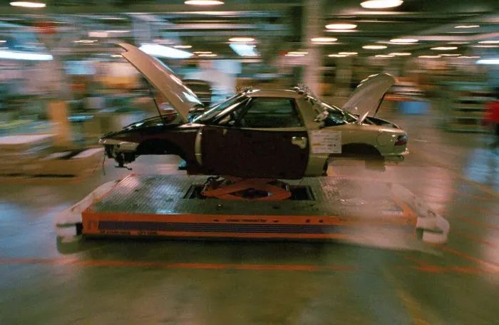 Framed Print : Partially Assembled Car Moving Through Work Station Framed Print : Partially Assembled Car Moving Through Work Station