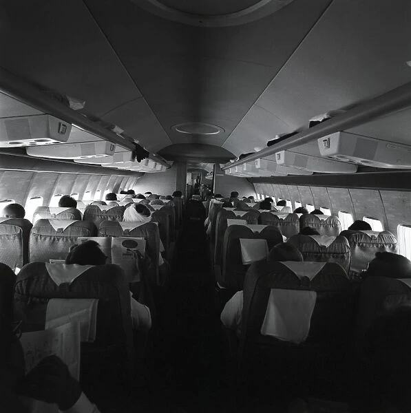 Passengers on airplane, rear view