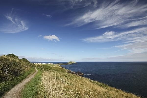 path along a cliff and a lighthouse in east cork in munster region