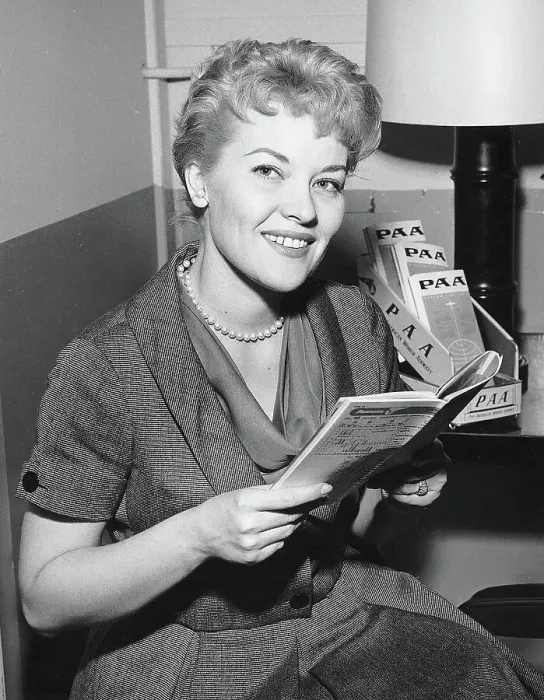 : Patti Page Looking At Flight Timetable : Patti Page Looking At Flight Timetable