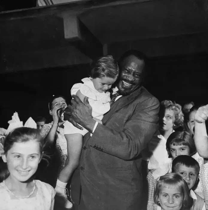 Framed Print : Paul Robeson Holding Young Child Near Group of Children Framed Print : Paul Robeson Holding Young Child Near Group of Children