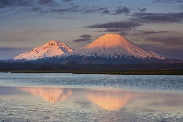 Payachata Volcanoes, twin volcanoes each standing over twenty thousand feet high, dominate the landscape in the Chilean Andes, Luaca National Park, Chile