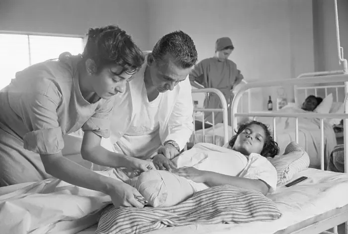 Framed Print : Peace Corp Nurse Attends to Patient with Amputated Leg Framed Print : Peace Corp Nurse Attends to Patient with Amputated Leg