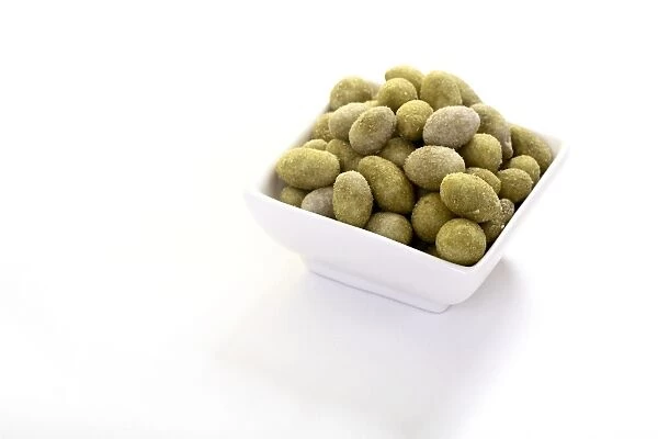 Peanuts in a Wasabi flavoured coating, in a bowl