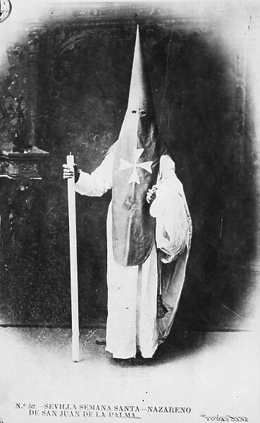 Penitent. January 1903: A priest dressed up for Penitent week in Seville
