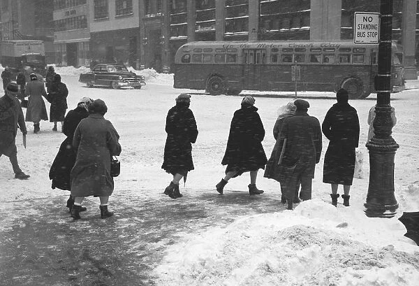 People on city street in winter, (B&W)