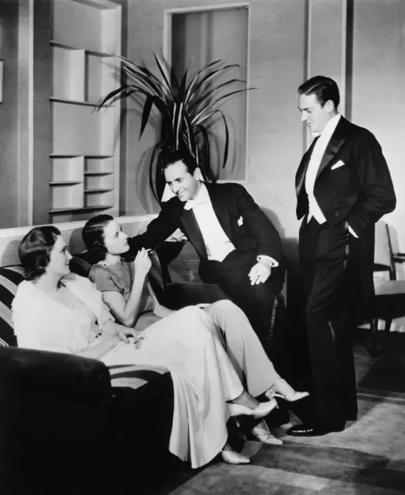 Framed Print : People in evening wear talking in living room (B&W) Framed Print : People in evening wear talking in living room (B&W)