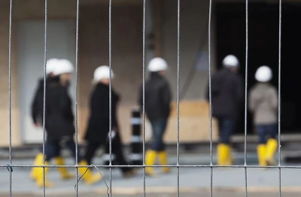 People in hard hats and rubber boots at a construction site, Elbe Philharmonic Hall, HafenCity, Hamburg, Germany