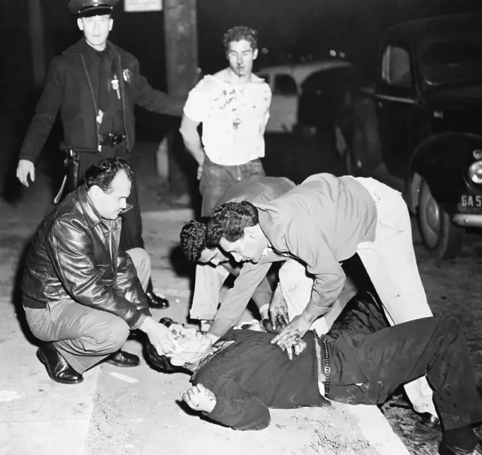 Framed Print : People Helping an Injured Man