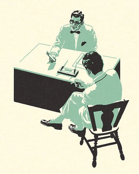 Two People Sitting at a Desk