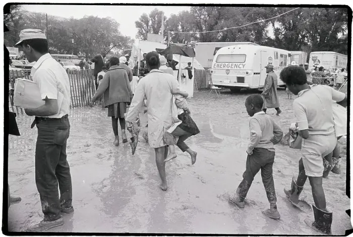 Framed Print : People Walking Through Mud At Camp Site Framed Print : People Walking Through Mud At Camp Site
