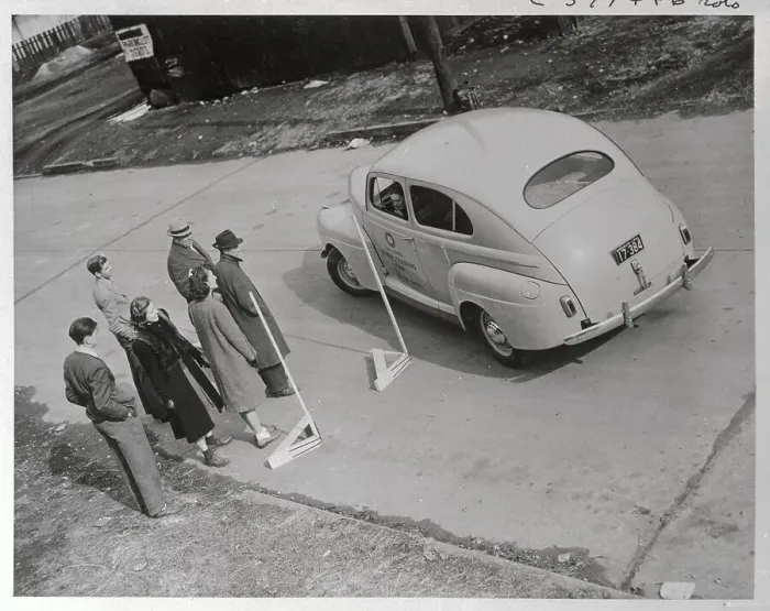Framed Print : People Watching Student Driver Parking