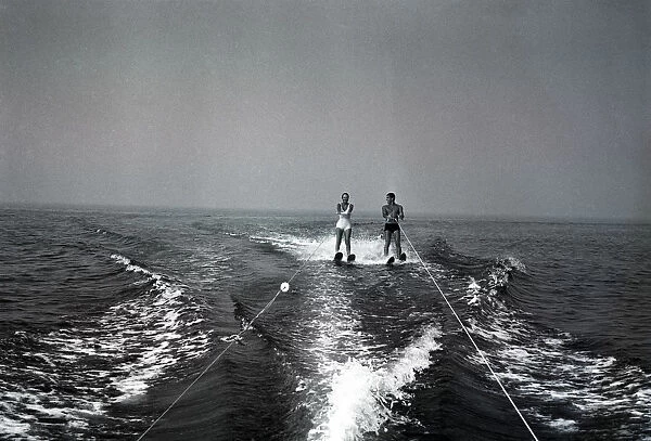 Two people waterskiing