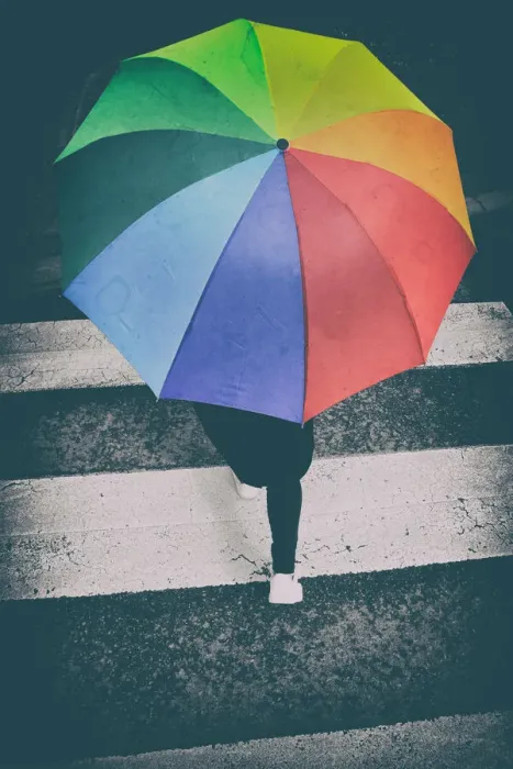 Framed Print : Person crossing a pedestrian crossing with a rainbow umbrella Framed Print : Person crossing a pedestrian crossing with a rainbow umbrella