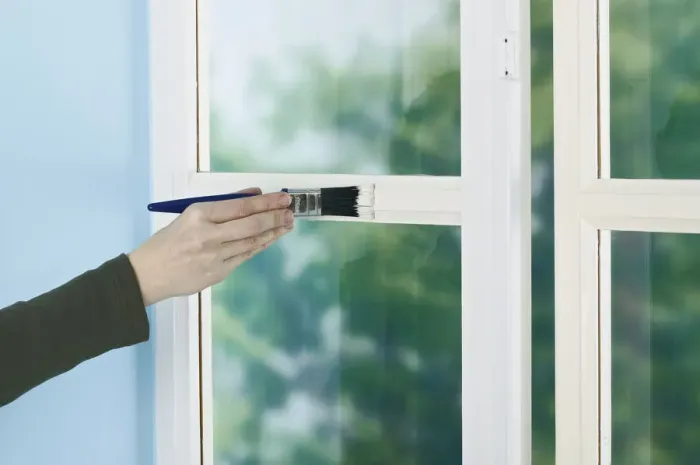 Framed Print : Person painting window frame with a brush Framed Print : Person painting window frame with a brush