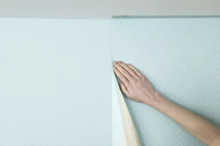 Framed Print : Person smoothing wall paper onto a wall Framed Print : Person smoothing wall paper onto a wall