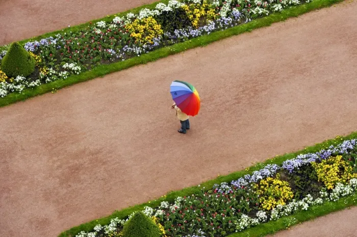 Framed Print : Person with umbrella in rainbow colors on a red gravel path between flower beds in the castle gardens, Fuldaer Stadtschloss City Palace, Fulda, Hesse, Germany Framed Print : Person with umbrella in rainbow colors on a red gravel path between flower beds in the castle gardens, Fuldaer Stadtschloss City Palace, Fulda, Hesse, Germany