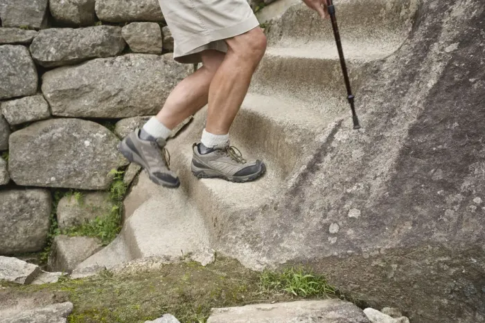 Framed Print : Peru, Machu Picchu, man climbing stone steps, low section Framed Print : Peru, Machu Picchu, man climbing stone steps, low section