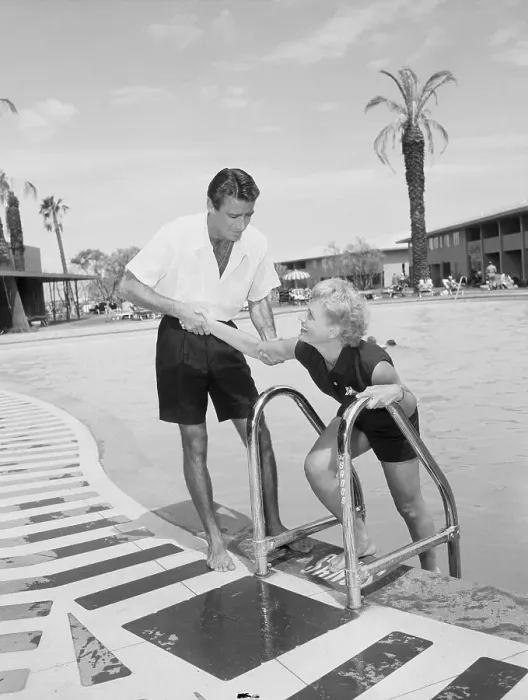 Framed Print : Peter Lawford Assisting Judy Holiday Poolside Framed Print : Peter Lawford Assisting Judy Holiday Poolside
