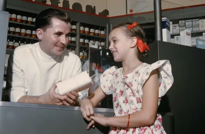 Framed Print : Pharmacy. NEW YORK - SEPTEMBER 1941: A Pharmacist serves a young girl in Framed Print : Pharmacy. NEW YORK - SEPTEMBER 1941: A Pharmacist serves a young girl in