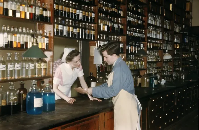 Framed Print : Pharmacy. NEW YORK - SEPTEMBER 1941: A Pharmacist consults with his assistant Framed Print : Pharmacy. NEW YORK - SEPTEMBER 1941: A Pharmacist consults with his assistant