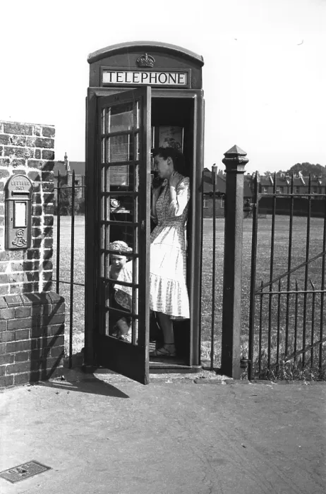 Framed Print : Phone Box. A woman and child in a telephone box Framed Print : Phone Box. A woman and child in a telephone box