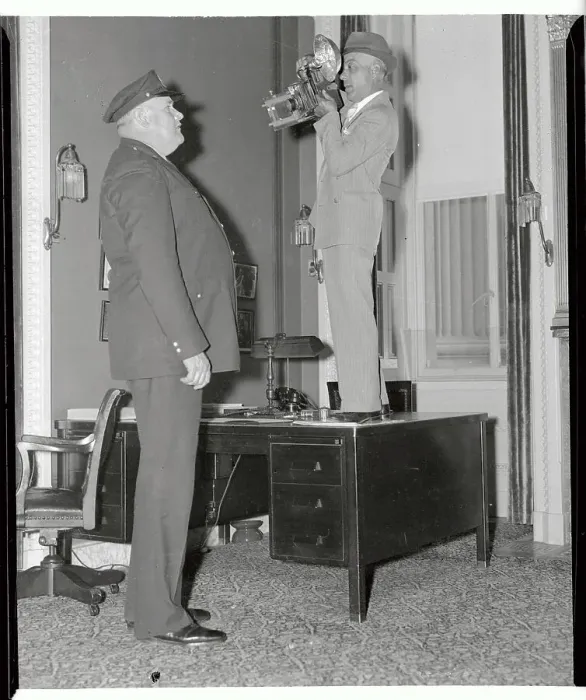 Framed Print : Photographer on Desk Photographing Cop Framed Print : Photographer on Desk Photographing Cop