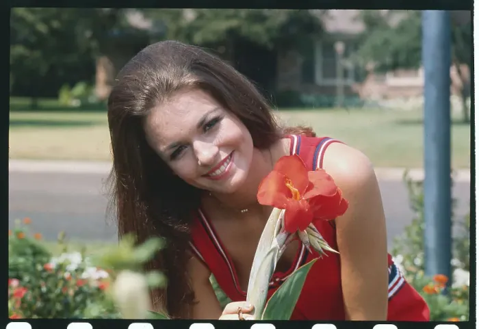 Framed Print : Phyllis George Holding a Flower Framed Print : Phyllis George Holding a Flower