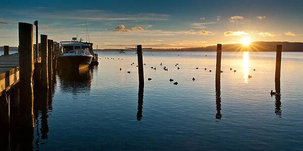 Pier at lake Rotorua with sunrise