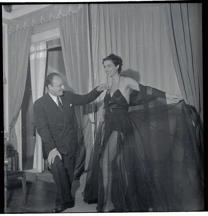 Framed Print : Pierre Balmain Adjusting Shoulder Strap of Model Framed Print : Pierre Balmain Adjusting Shoulder Strap of Model