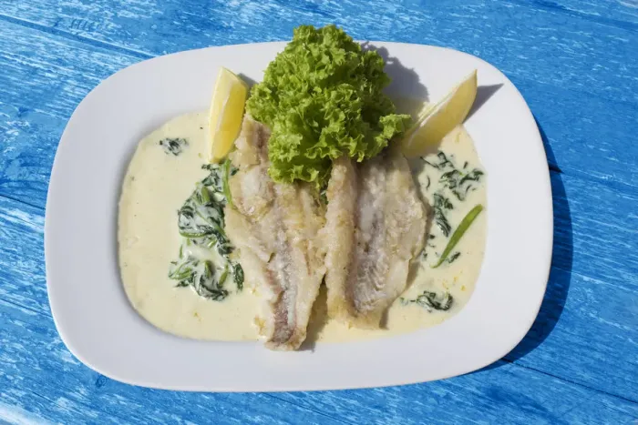 Framed Print : Pike-perch fillet on a bed of spinach with cream sauce Framed Print : Pike-perch fillet on a bed of spinach with cream sauce