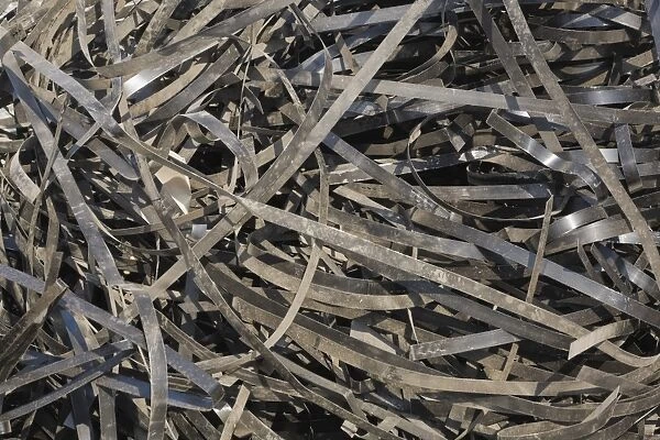 Pile of discarded metal straps at a scrap metal recycling centre, Quebec, Canada